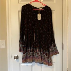 Dress with bell sleeves and front lace up feature